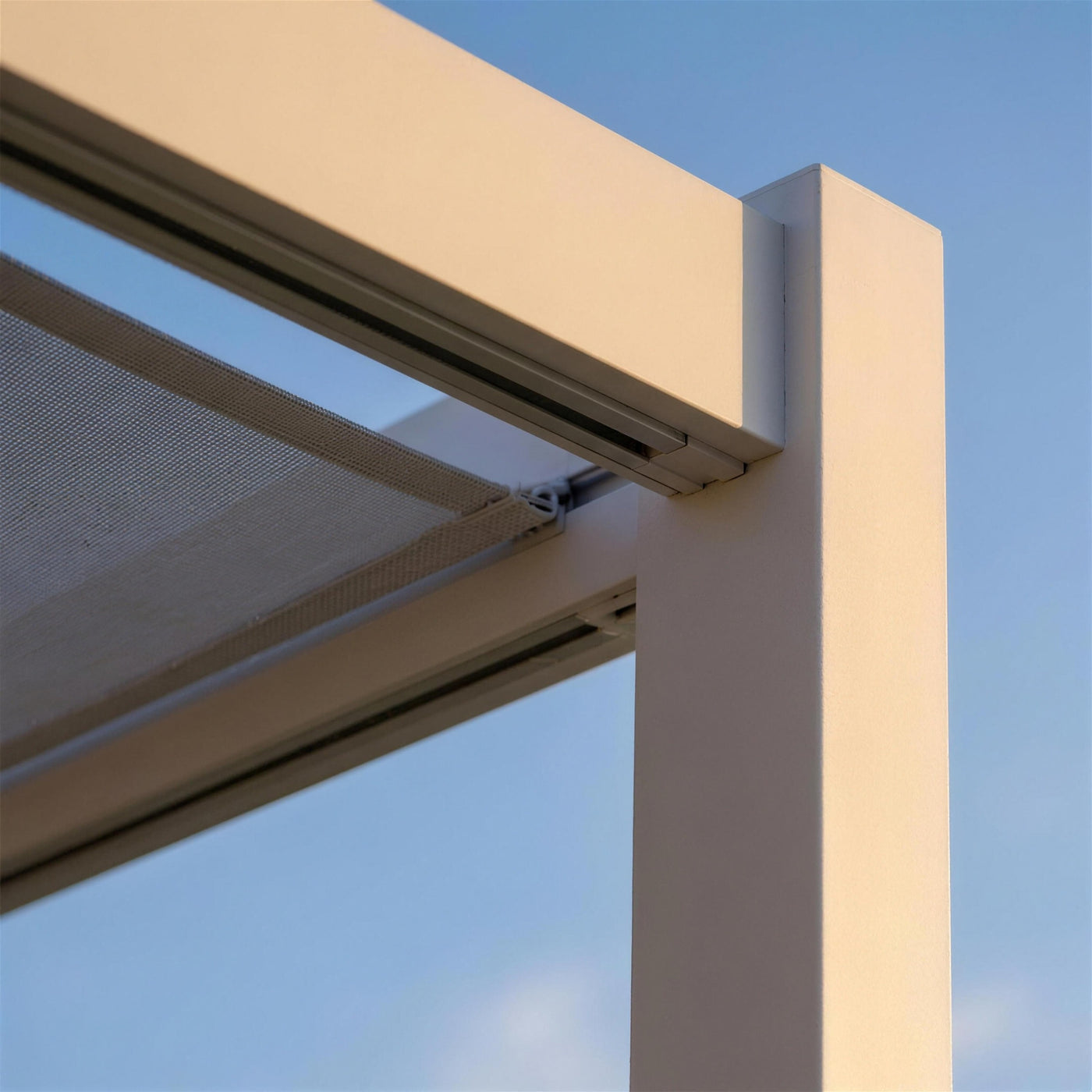 Detalle del perfil de aluminio blanco de la pergola Venecia con el carril por el que corre el toldo